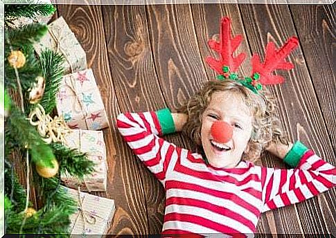 Little girl at Christmas with reindeer antlers.  Christmas activities for children.