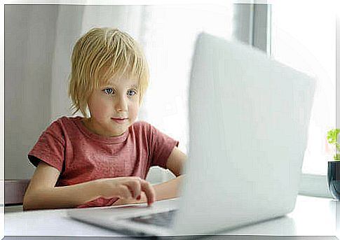 Child using computer to play video games.