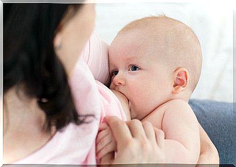 woman breastfeeding child 