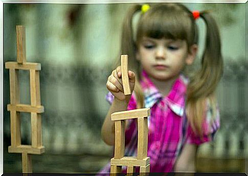 Little girl playing with buildings