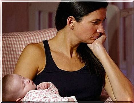 exhausted mom holds her daughter in her arms