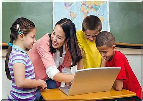 Teacher and children in front of the computer