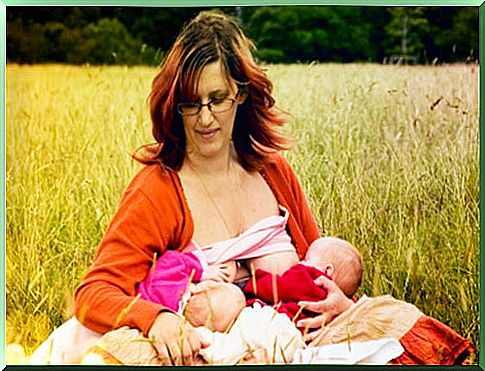 woman breastfeeds twins