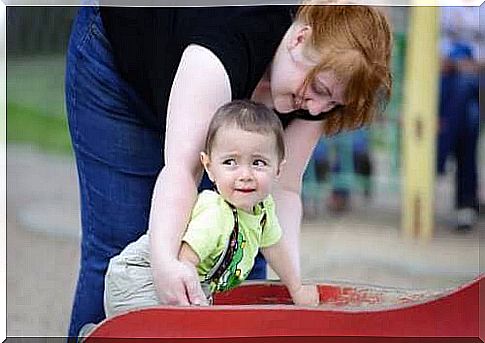 Baby plays with his mom