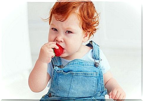 Child eating a strawberry