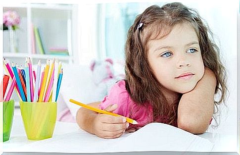 Little girl gets distracted while doing homework