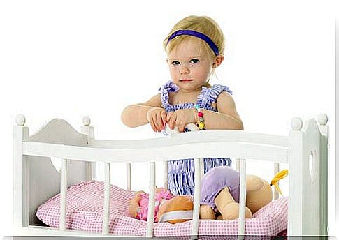 Little girl sitting in the cot