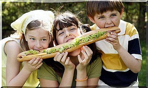 Children sharing a giant sandwich.