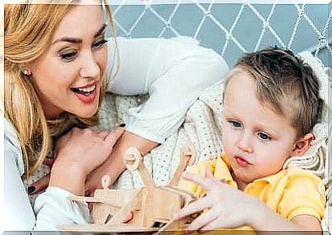 Child with mother and wooden toy