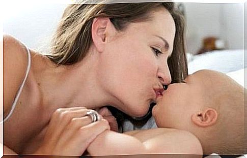 Kissing the son on the mouth.