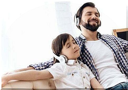 Dad and daughter listening to music