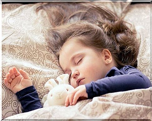 Little girl sleeping with a soft toy